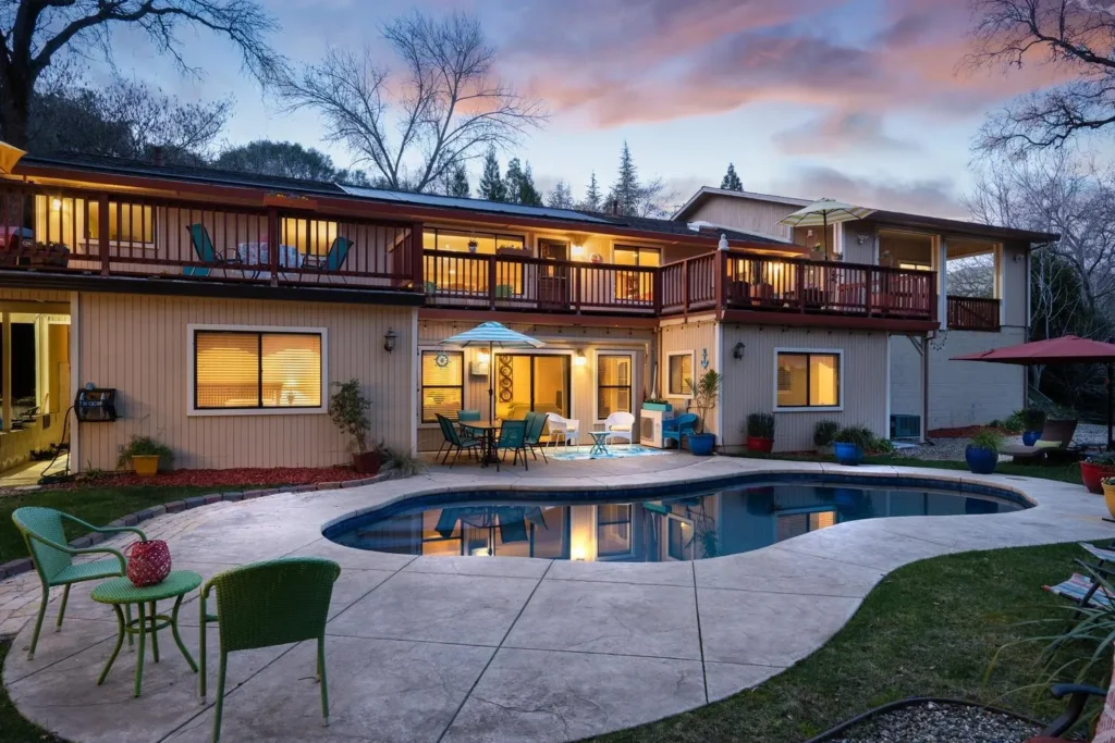 Spacious two-story Kerr Lake home with balcony and evening lights — Virginia real estate listing